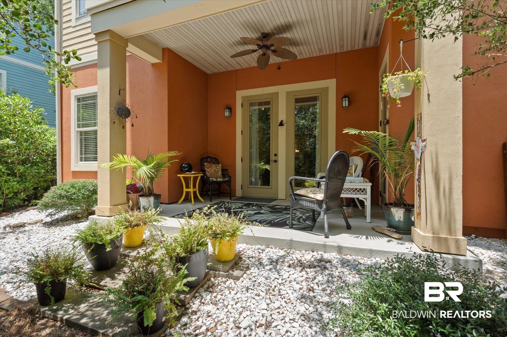 1430 Regency Road, Unit C103 Gulf Shores, AL 36542 - Photo 16 of 29 View of back entry with a ceiling fan, stucco siding, and a patio area