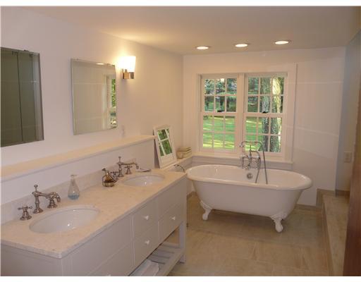 362 Mill Road Stamford, CT 06903 - Photo 16 of 20 a bathroom with a double vanity sink and a bathtub