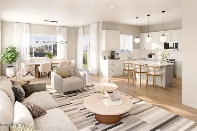 a living room with furniture kitchen and a table