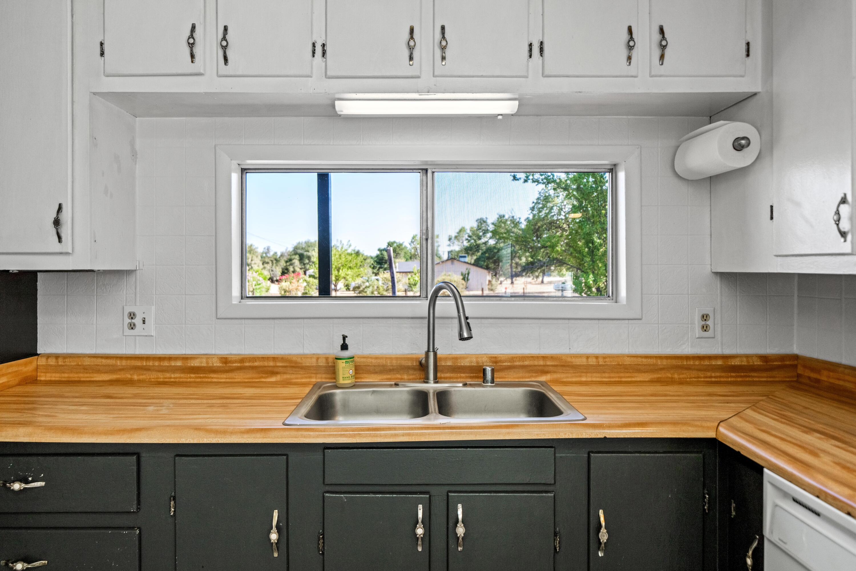 19825 Gas Point Road Cottonwood, CA 96022 - Photo 11 of 54 a kitchen with a sink cabinets and window