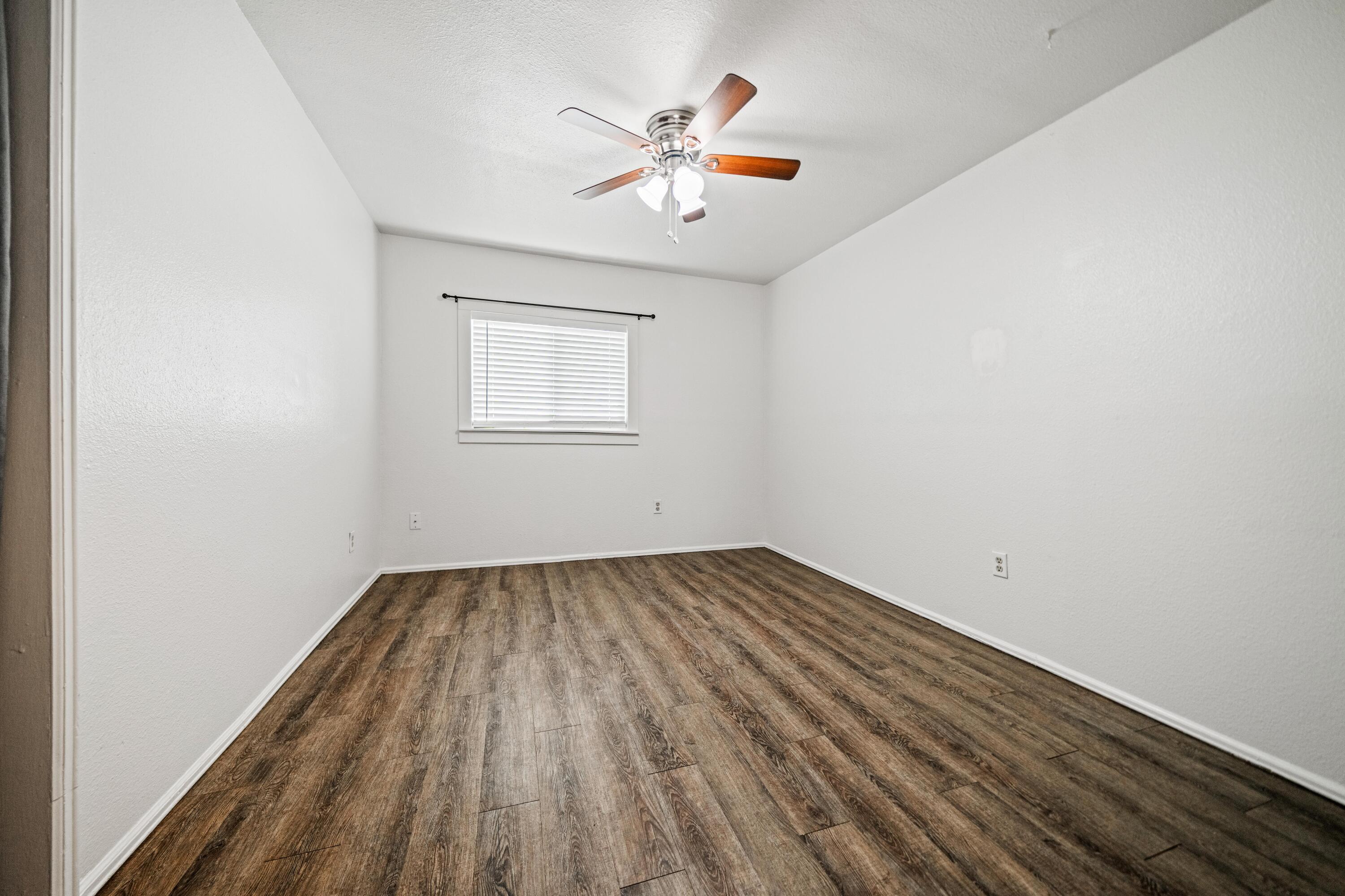 19825 Gas Point Road Cottonwood, CA 96022 - Photo 17 of 54 an empty room with wooden floor and windows