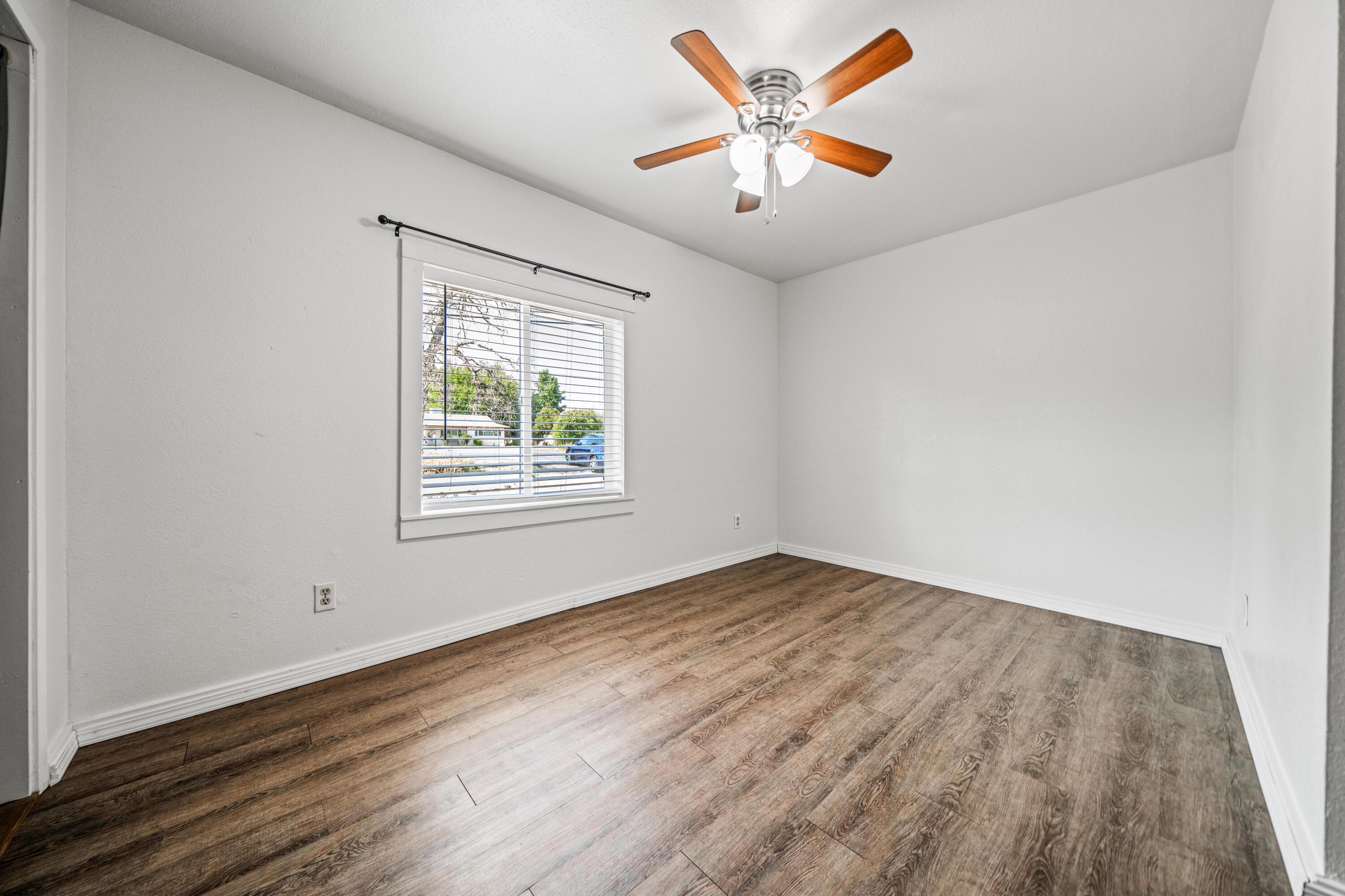 19825 Gas Point Road Cottonwood, CA 96022 - Photo 20 of 54 an empty room with wooden floor and windows