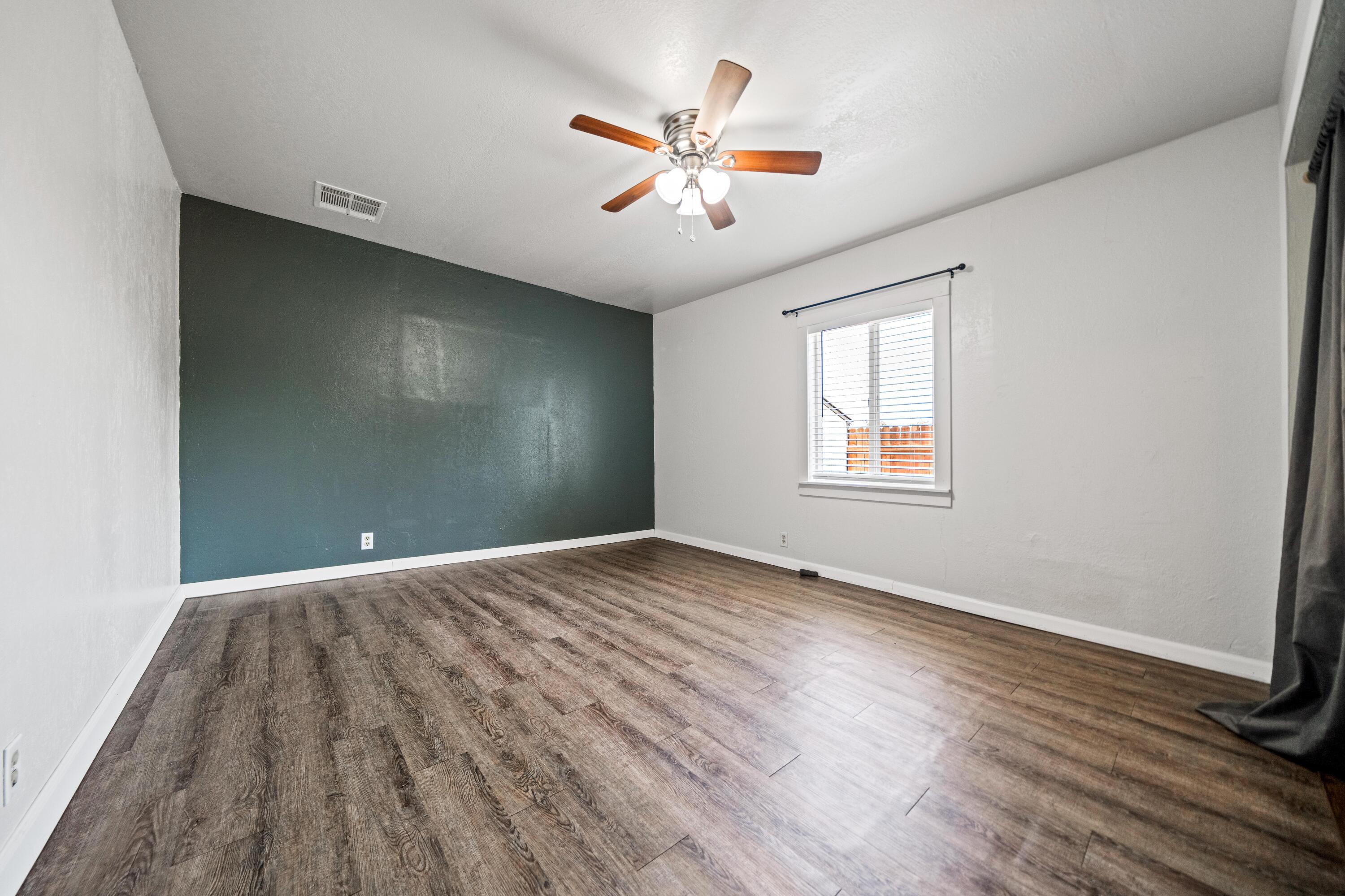19825 Gas Point Road Cottonwood, CA 96022 - Photo 21 of 54 an empty room with wooden floor and windows