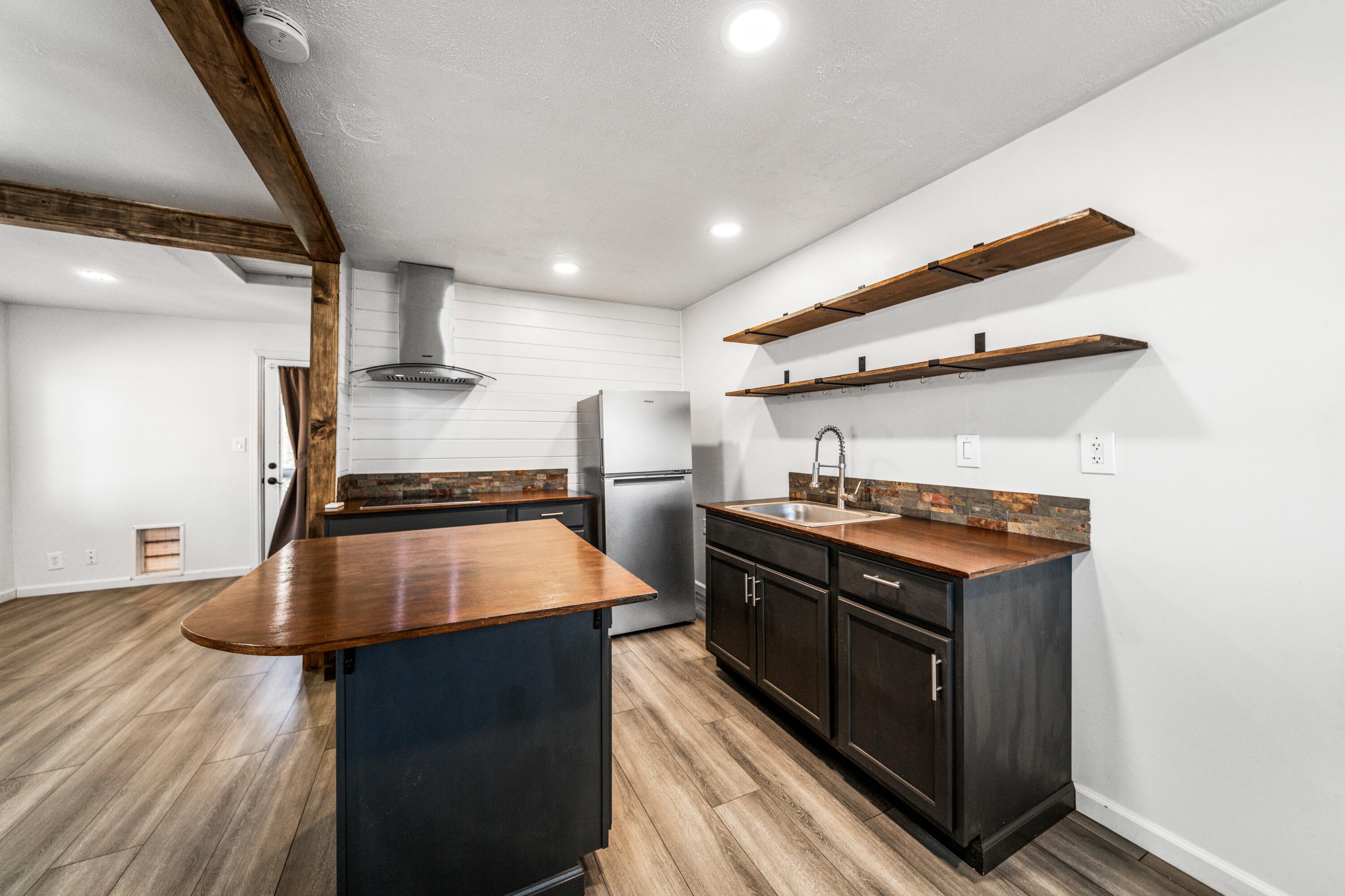 19825 Gas Point Road Cottonwood, CA 96022 - Photo 35 of 54 a kitchen with wooden cabinets and stainless steel appliances