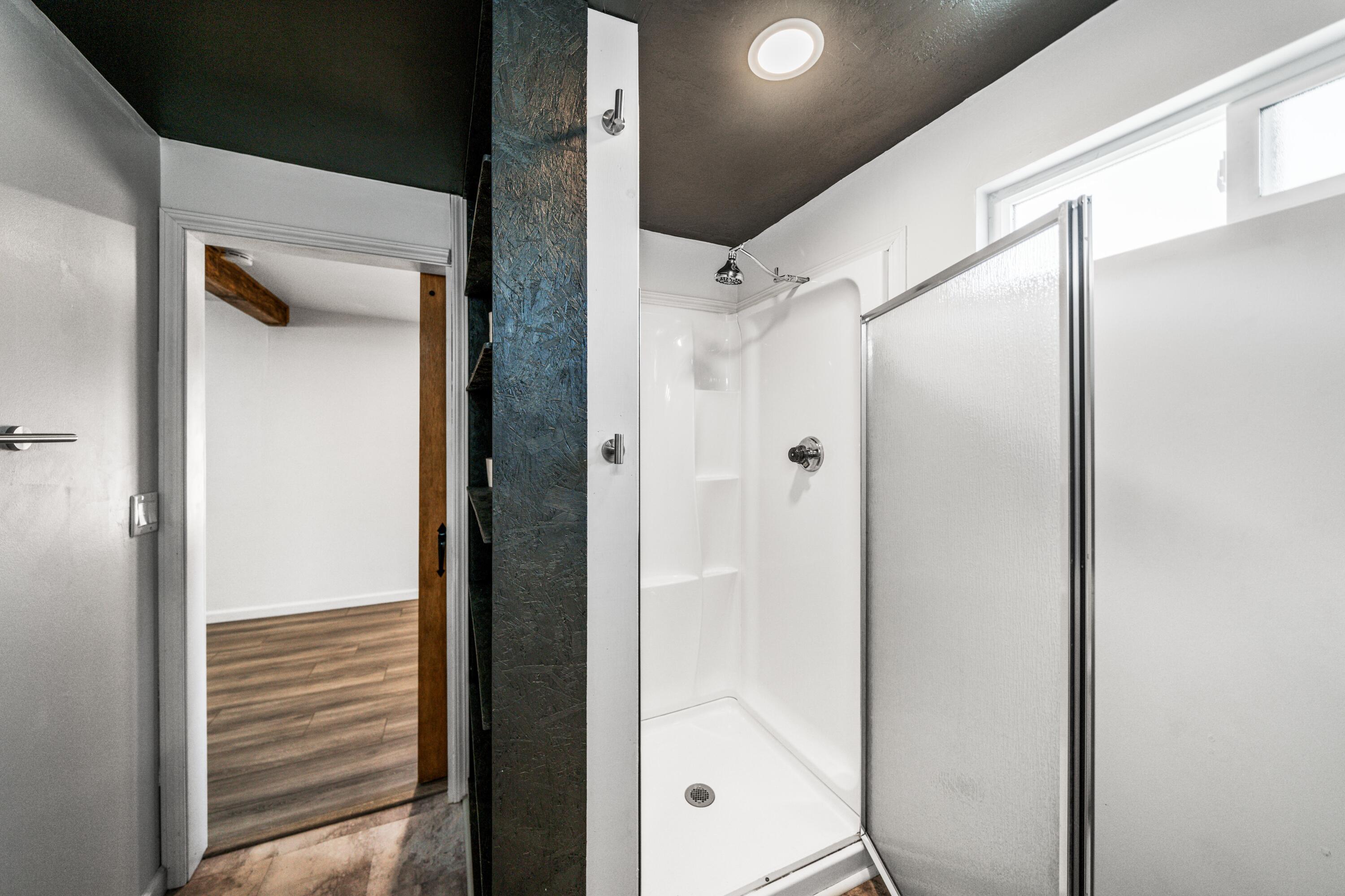 19825 Gas Point Road Cottonwood, CA 96022 - Photo 45 of 54 a bathroom with a glass shower door and a bathtub