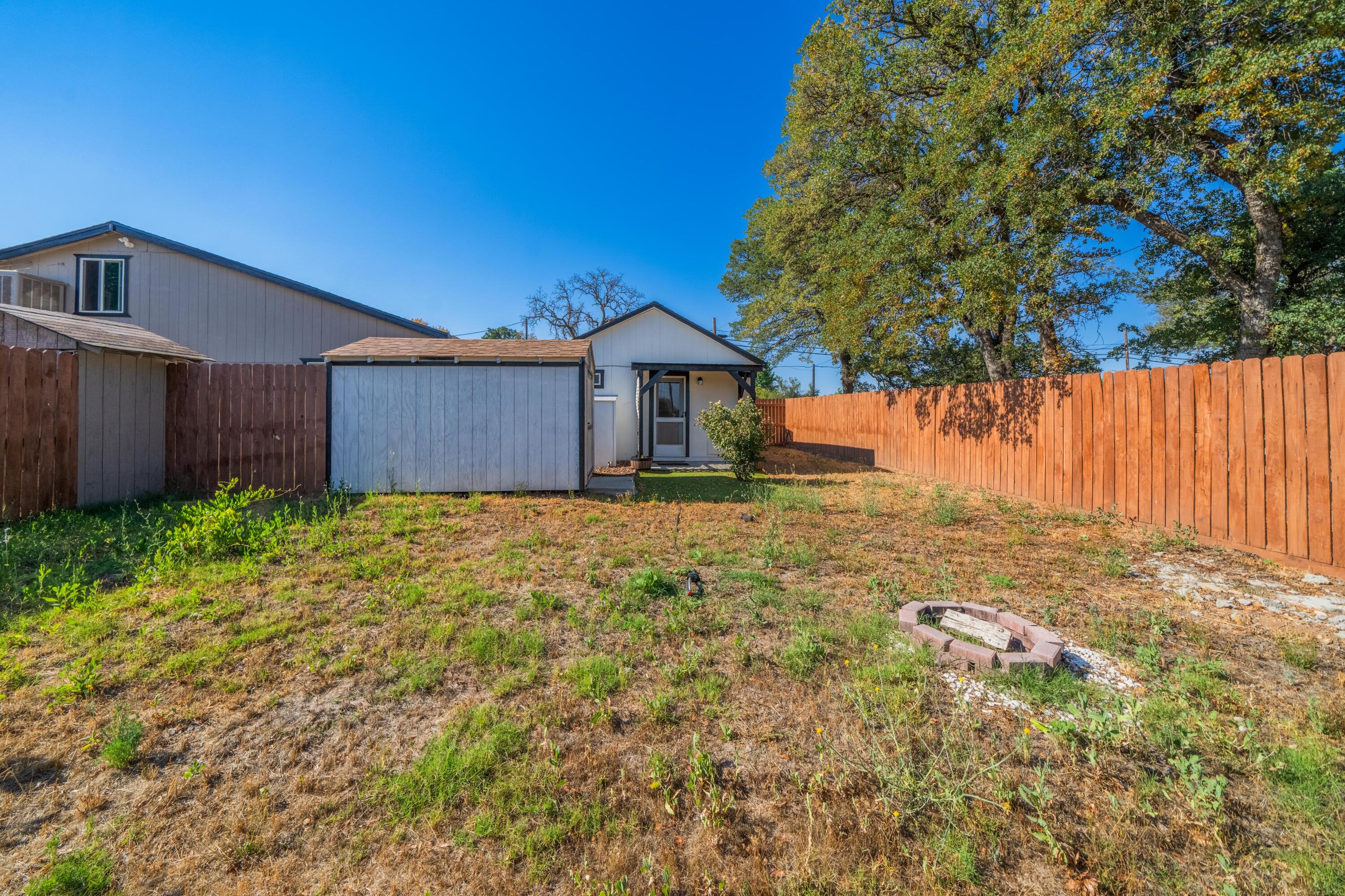 19825 Gas Point Road Cottonwood, CA 96022 - Photo 51 of 54 a front view of a house with a yard and garage