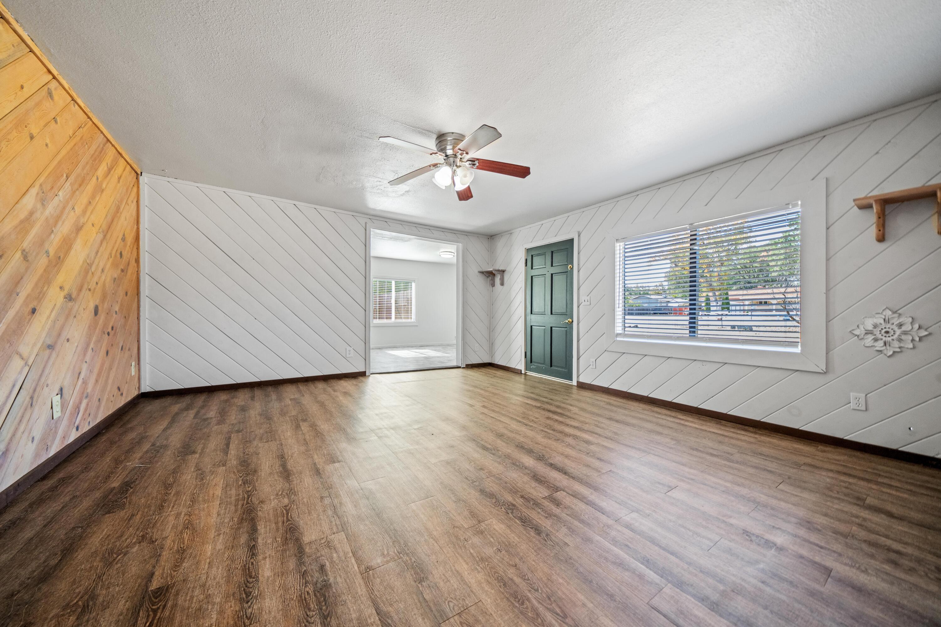 19825 Gas Point Road Cottonwood, CA 96022 - Photo 7 of 54 a view of an empty room with wooden floor and a window