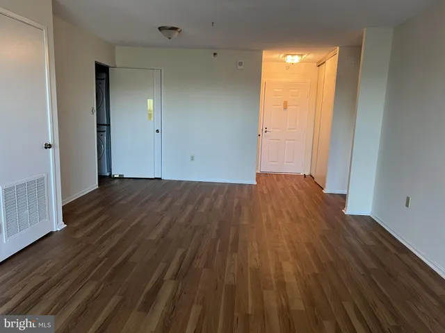 a view of a room with wooden floor
