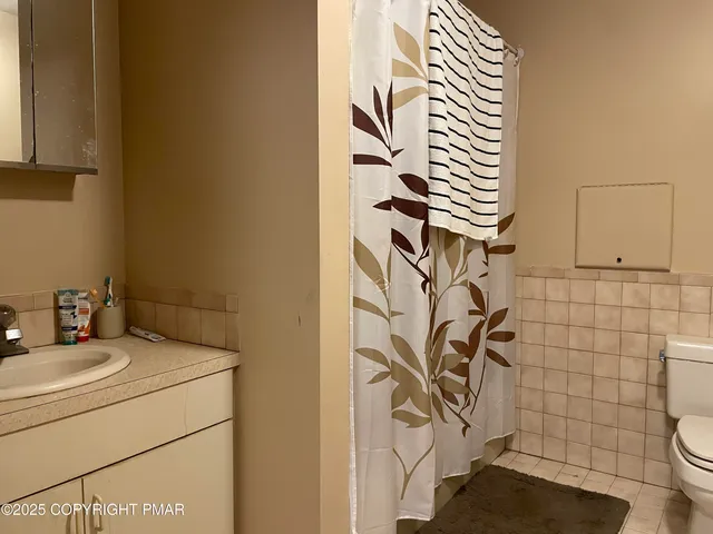 a bathroom with a sink and a shower curtain