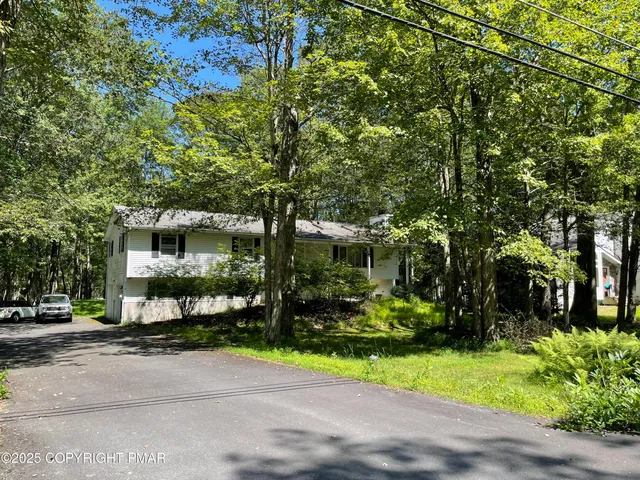 a front view of a house with a yard and a garage