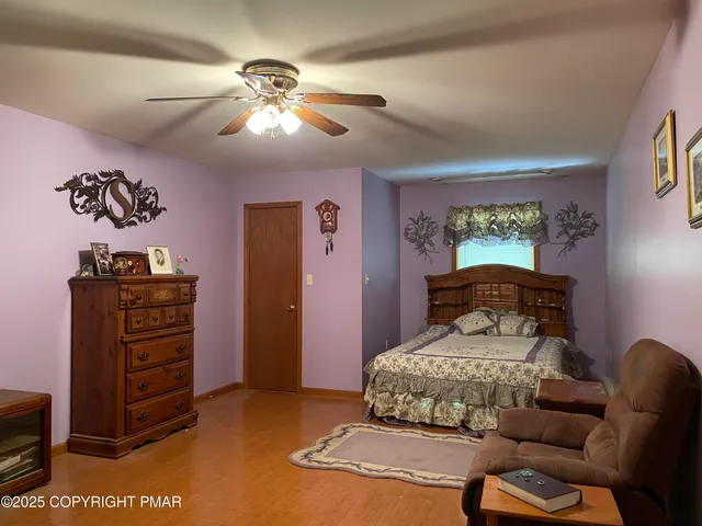a bedroom with furniture and wooden floor