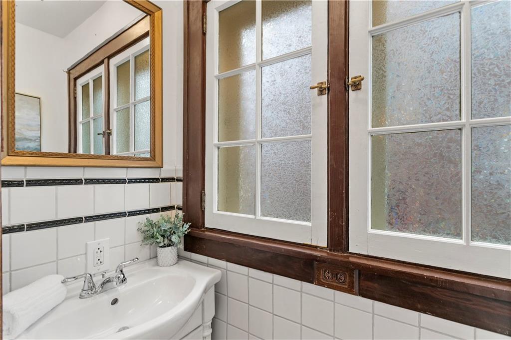 6953 Reynolds Street Pittsburgh, PA 15208 - Photo 15 of 50 a bathroom with a sink and a mirror