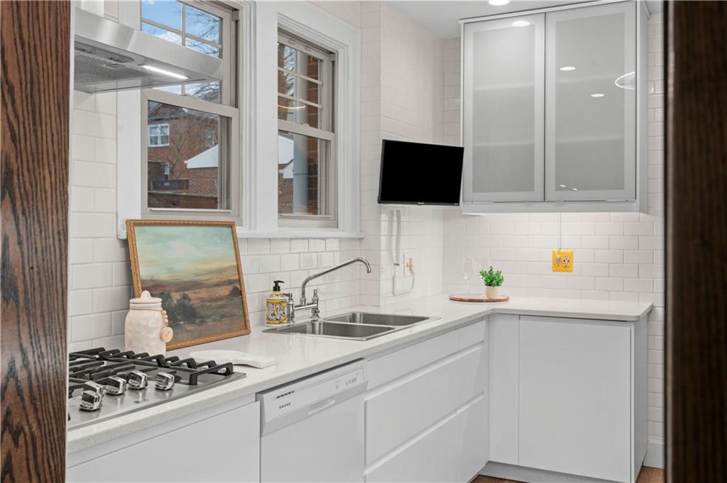 6953 Reynolds Street Pittsburgh, PA 15208 - Photo 23 of 50 a kitchen with stainless steel appliances a sink stove and cabinets