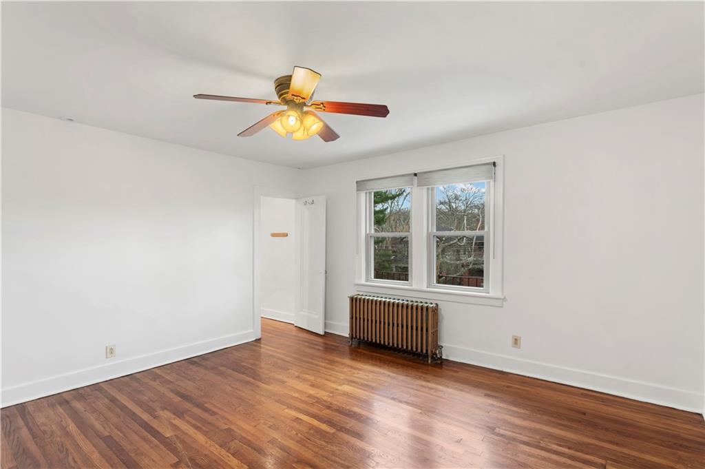 6953 Reynolds Street Pittsburgh, PA 15208 - Photo 30 of 50 a view of an empty room with wooden floor and a window