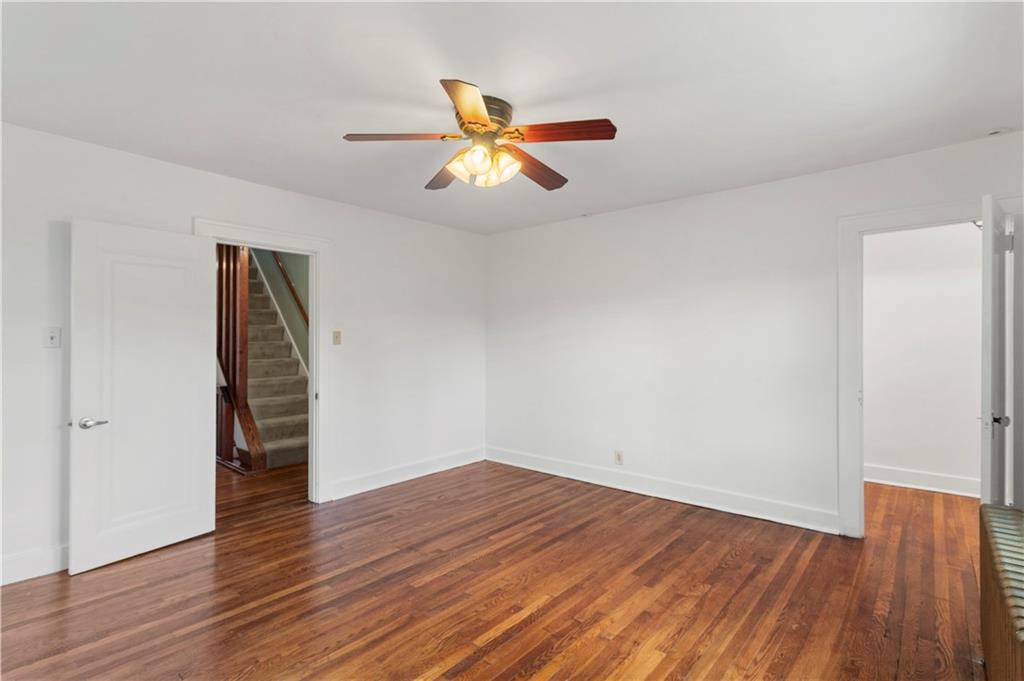6953 Reynolds Street Pittsburgh, PA 15208 - Photo 31 of 50 an empty room with wooden floor closet and windows