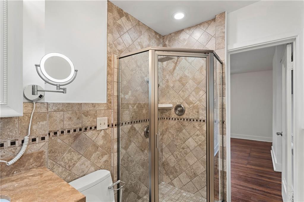 6953 Reynolds Street Pittsburgh, PA 15208 - Photo 34 of 50 a bathroom with a glass shower door and a sink
