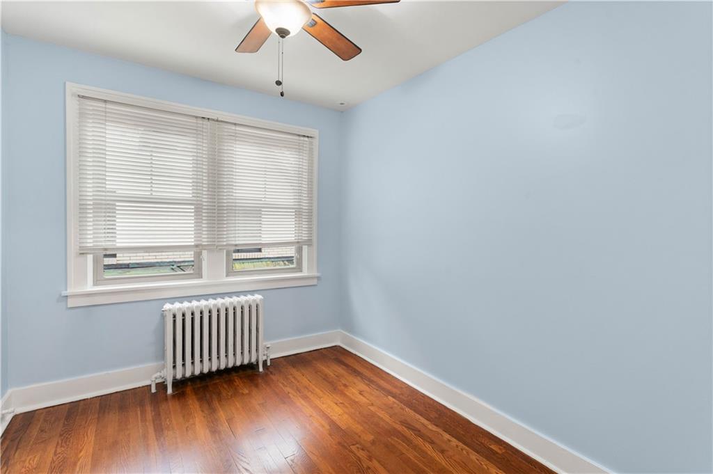 6953 Reynolds Street Pittsburgh, PA 15208 - Photo 37 of 50 an empty room with wooden floor and windows