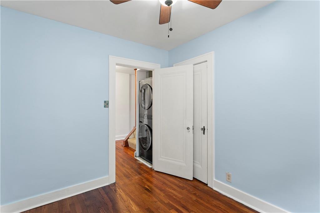 6953 Reynolds Street Pittsburgh, PA 15208 - Photo 38 of 50 an empty room with wooden floor and a ceiling fan