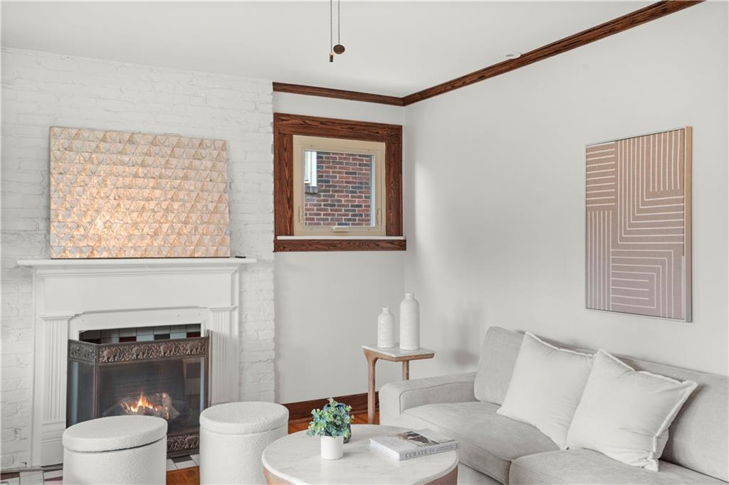 6953 Reynolds Street Pittsburgh, PA 15208 - Photo 6 of 50 a living room with furniture a fireplace and a large mirror