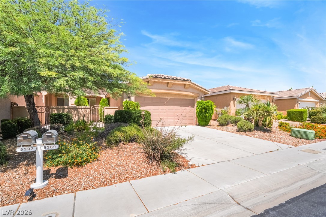 5389 Progresso Street Las Vegas, NV 89135 - Photo 4 of 41 Mature trees and low-maintenance landscaping enhance the welcoming curb appeal of this property.