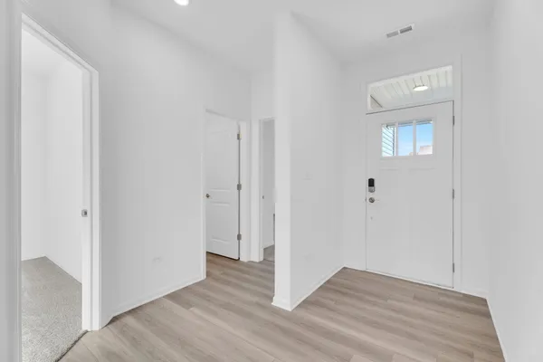 a view of an empty room and wooden floor