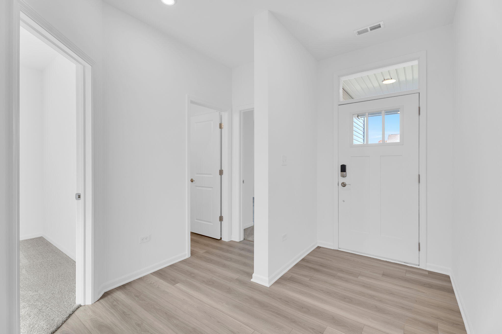 12535 Virginia Street Crown Point, IN 46307 - Photo 2 of 16 a view of an empty room and wooden floor