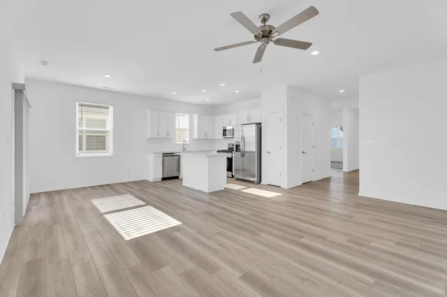 a view of kitchen with granite countertop cabinets and wooden floor