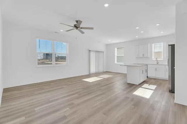 a view of empty room with wooden floor and window