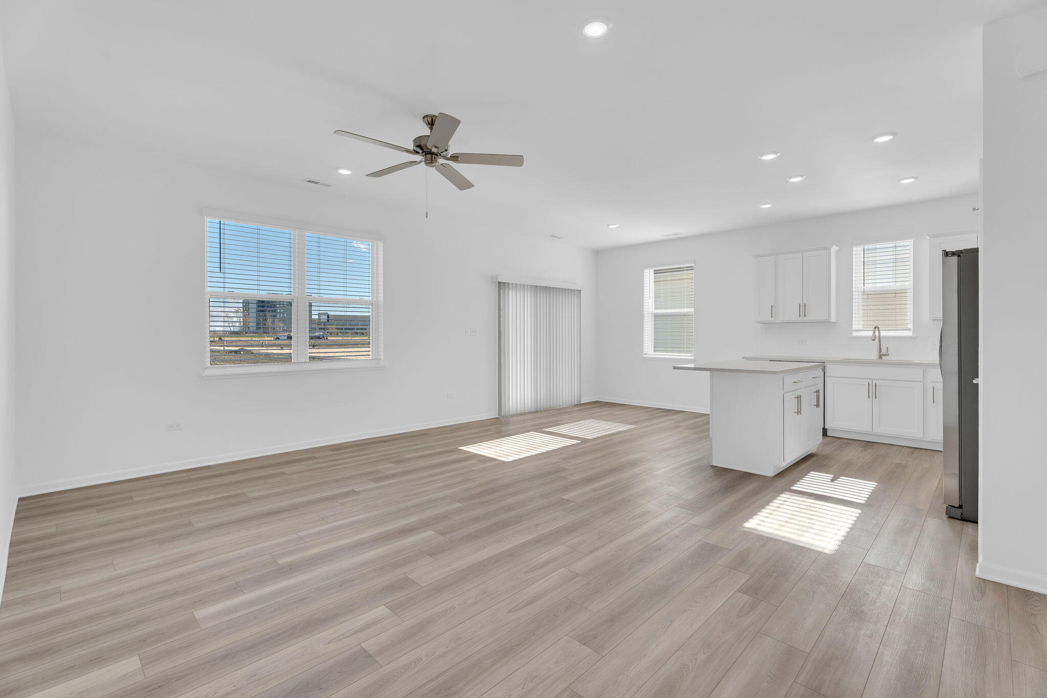 12535 Virginia Street Crown Point, IN 46307 - Photo 4 of 16 a view of empty room with wooden floor and window