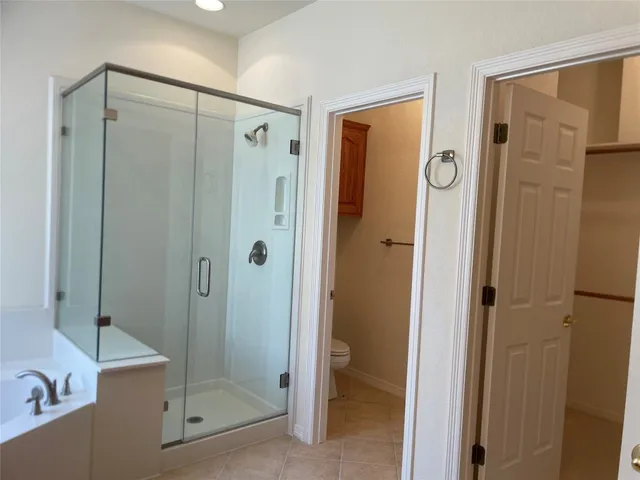 a bathroom with a shower and a glass door