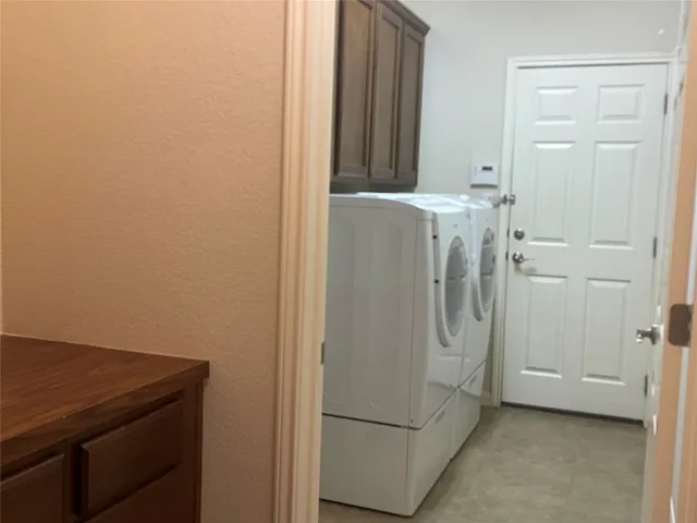 a room with a refrigerator and cabinets