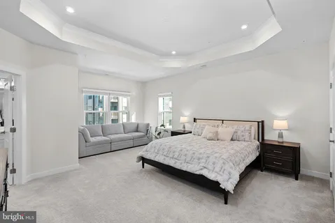 a bedroom with a bed and couch