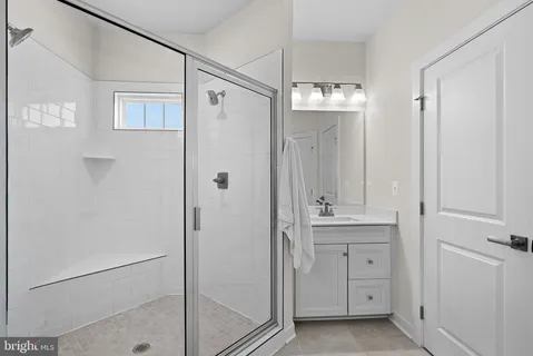 a bathroom with a shower and a sink