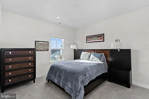 a bedroom with a bed and cabinet