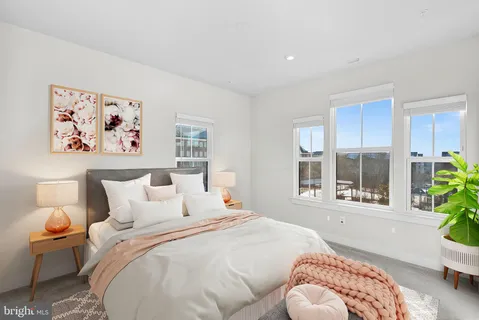 a bedroom with bed and a window