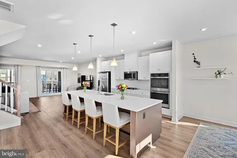a large kitchen with a table and chairs