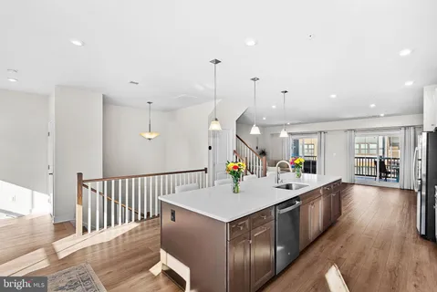 a kitchen with counter top space and wooden floor