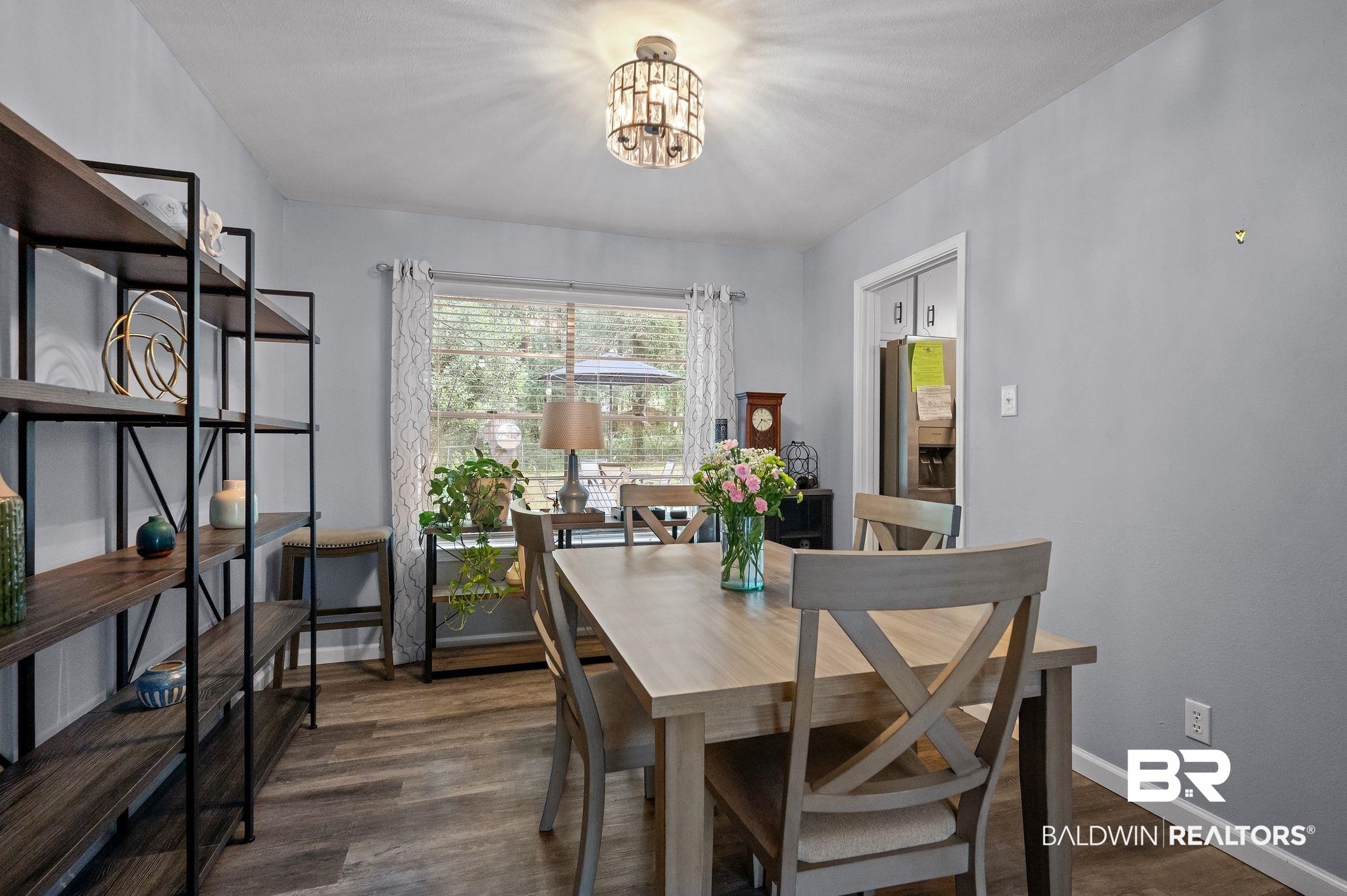 4724 Wicker Way Mobile, AL 36609 - Photo 8 of 36 Dining area featuring wood-finish flooring, a window with horizontal blinds, and a contemporary ceiling fixture