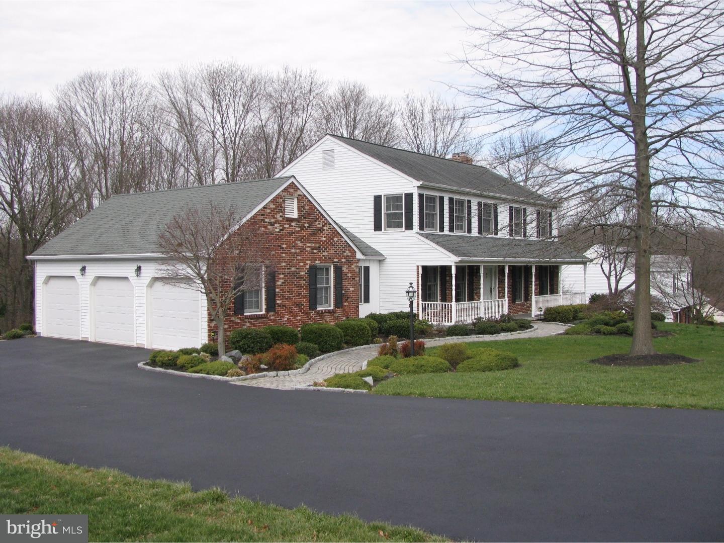11 Raphael Road Hockessin, DE 19707 - Photo 2 of 25 a front view of a house with a garden and trees