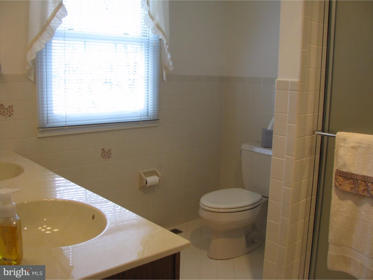 11 Raphael Road Hockessin, DE 19707 - Photo 16 of 25 a bathroom with a sink and a toilet