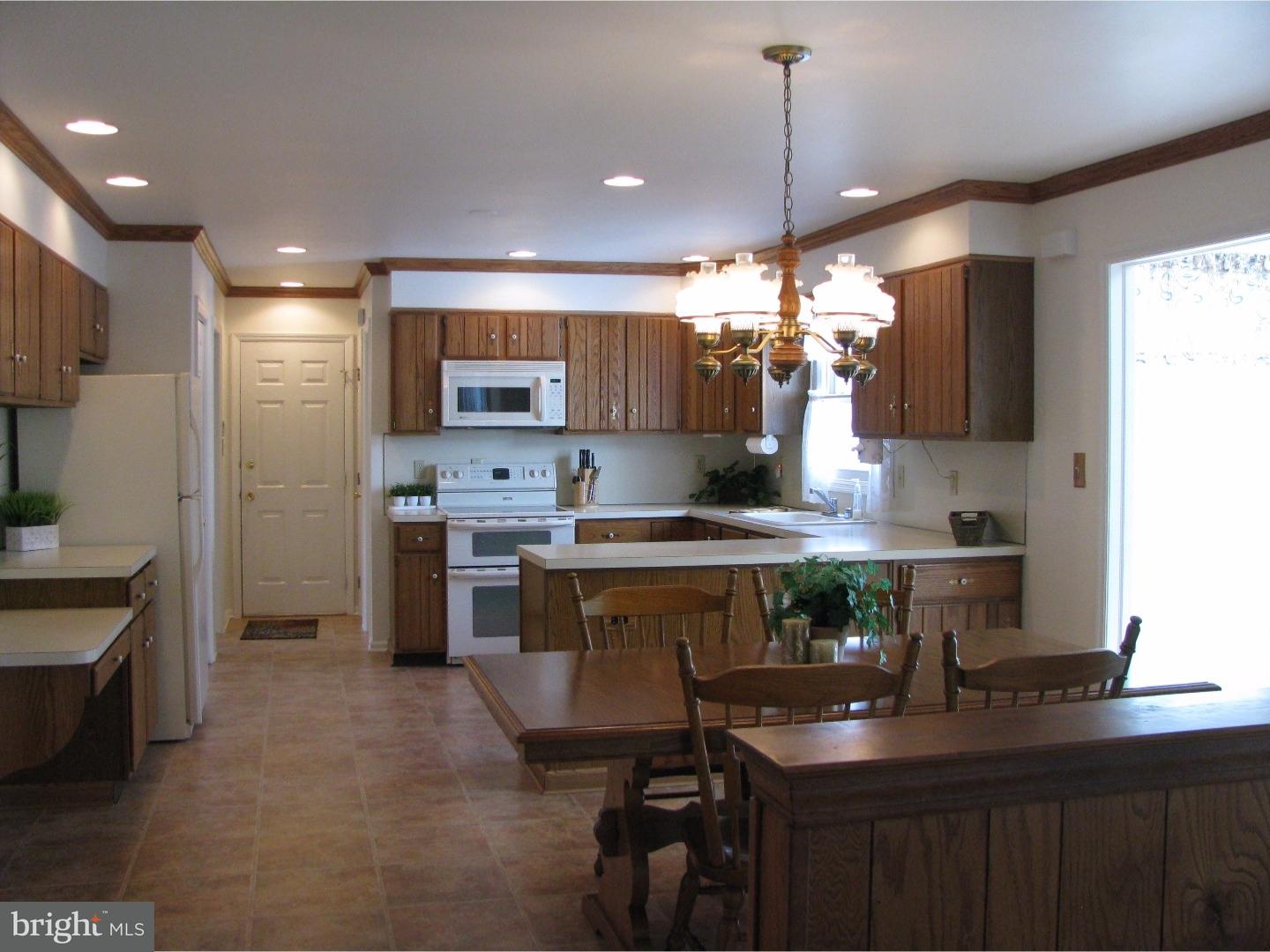 11 Raphael Road Hockessin, DE 19707 - Photo 7 of 25 a kitchen with a sink refrigerator and cabinets