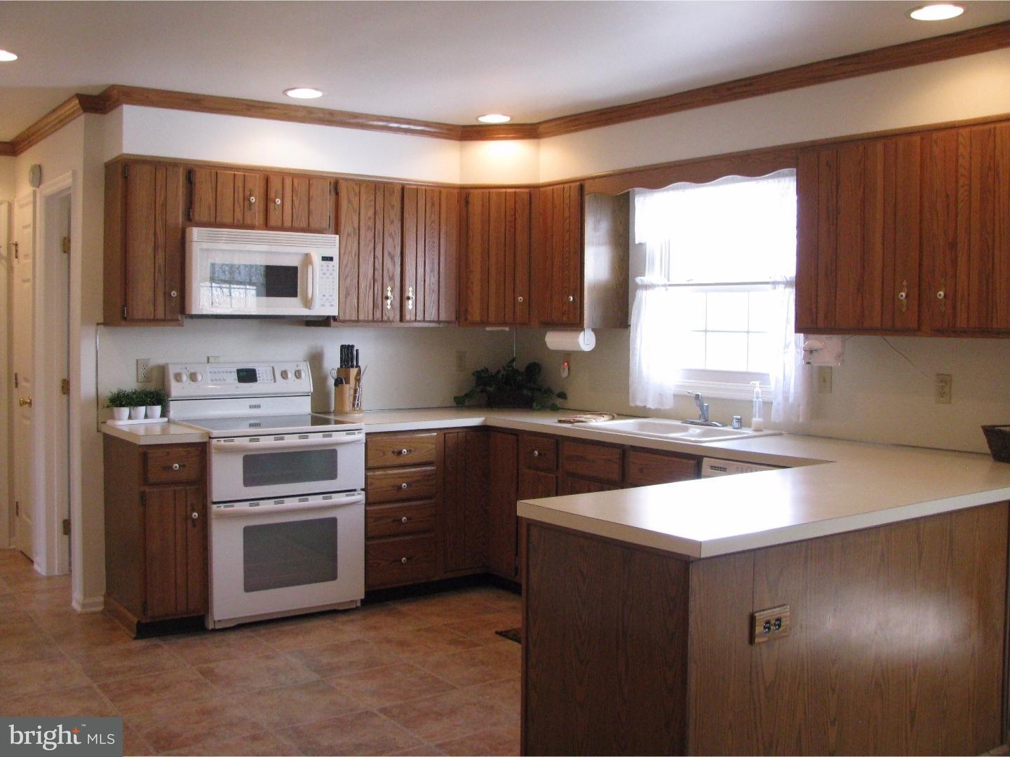 11 Raphael Road Hockessin, DE 19707 - Photo 8 of 25 a kitchen with a stove a sink and a microwave