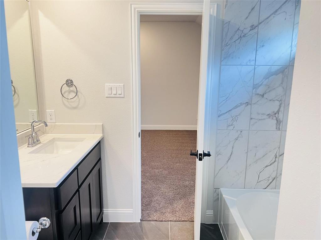 6825 Entwistle Road Frisco, TX 75034 - Photo 23 of 33 a bathroom with a sink and a mirror