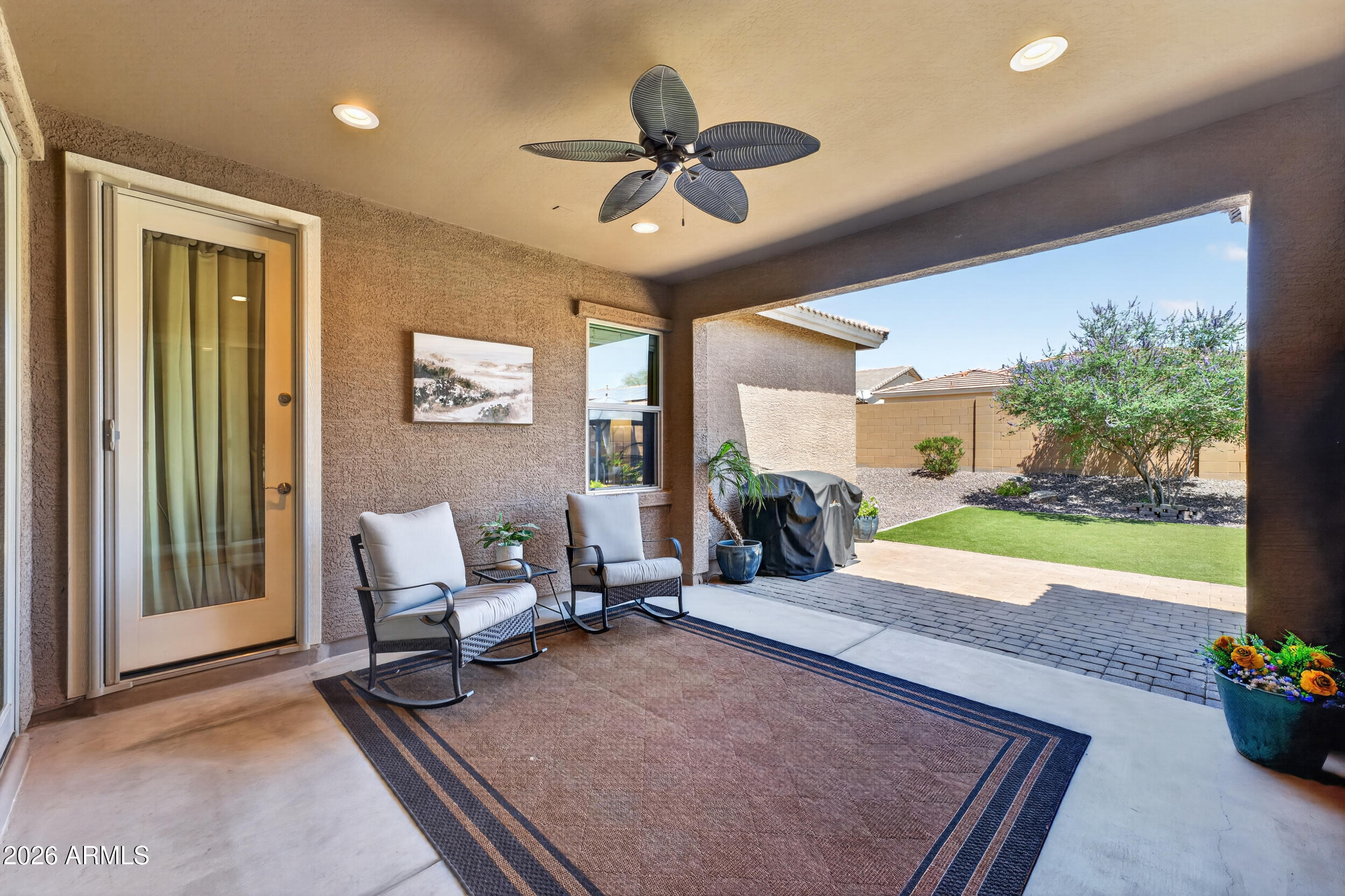 18612 West Mountain View Road Waddell, AZ 85355 - Photo 43 of 71 a living room with patio furniture and a floor to ceiling window