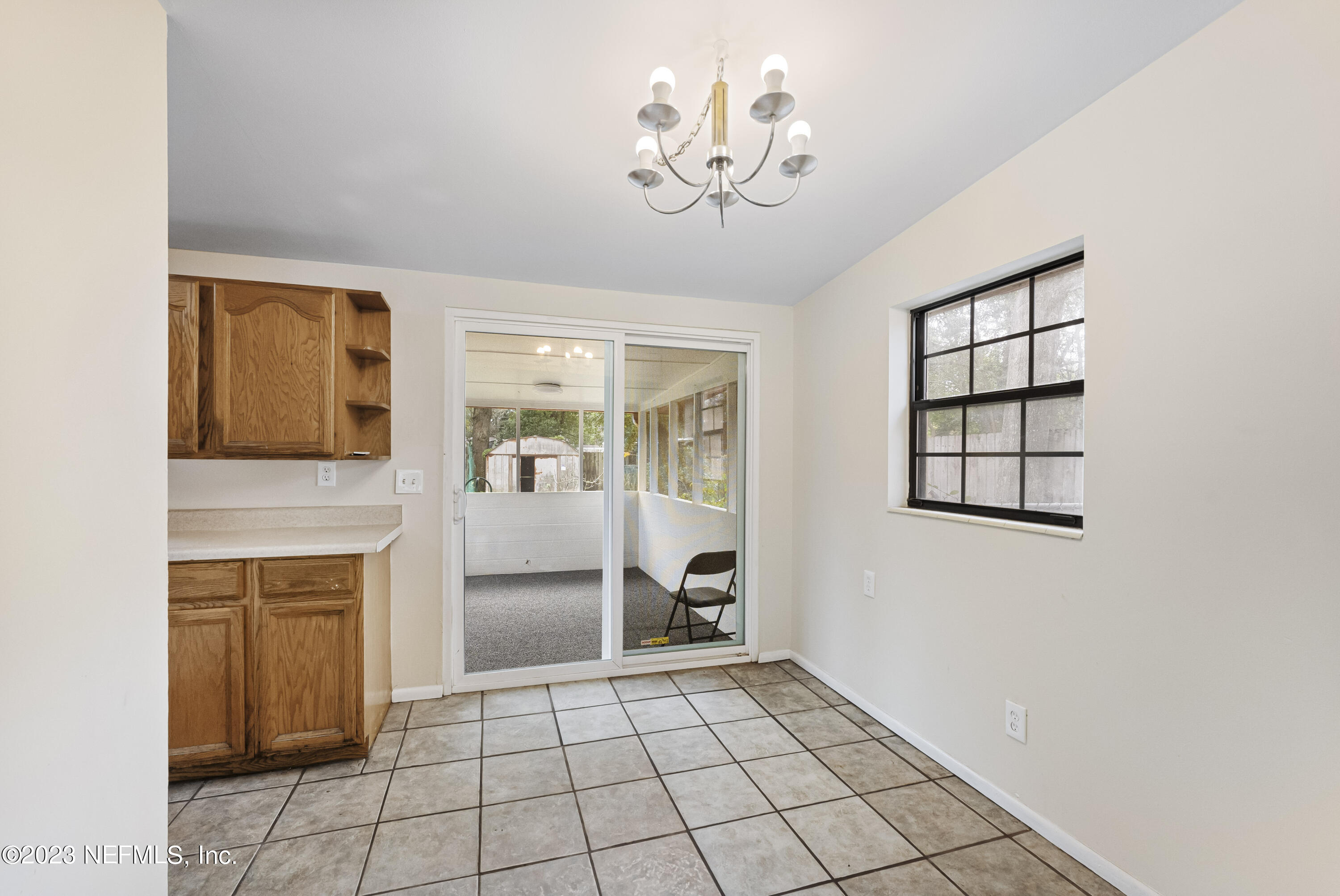 7520 Ridgeway Road East Jacksonville, FL 32244 - Photo 5 of 16 a view of an empty room with a fireplace and a window