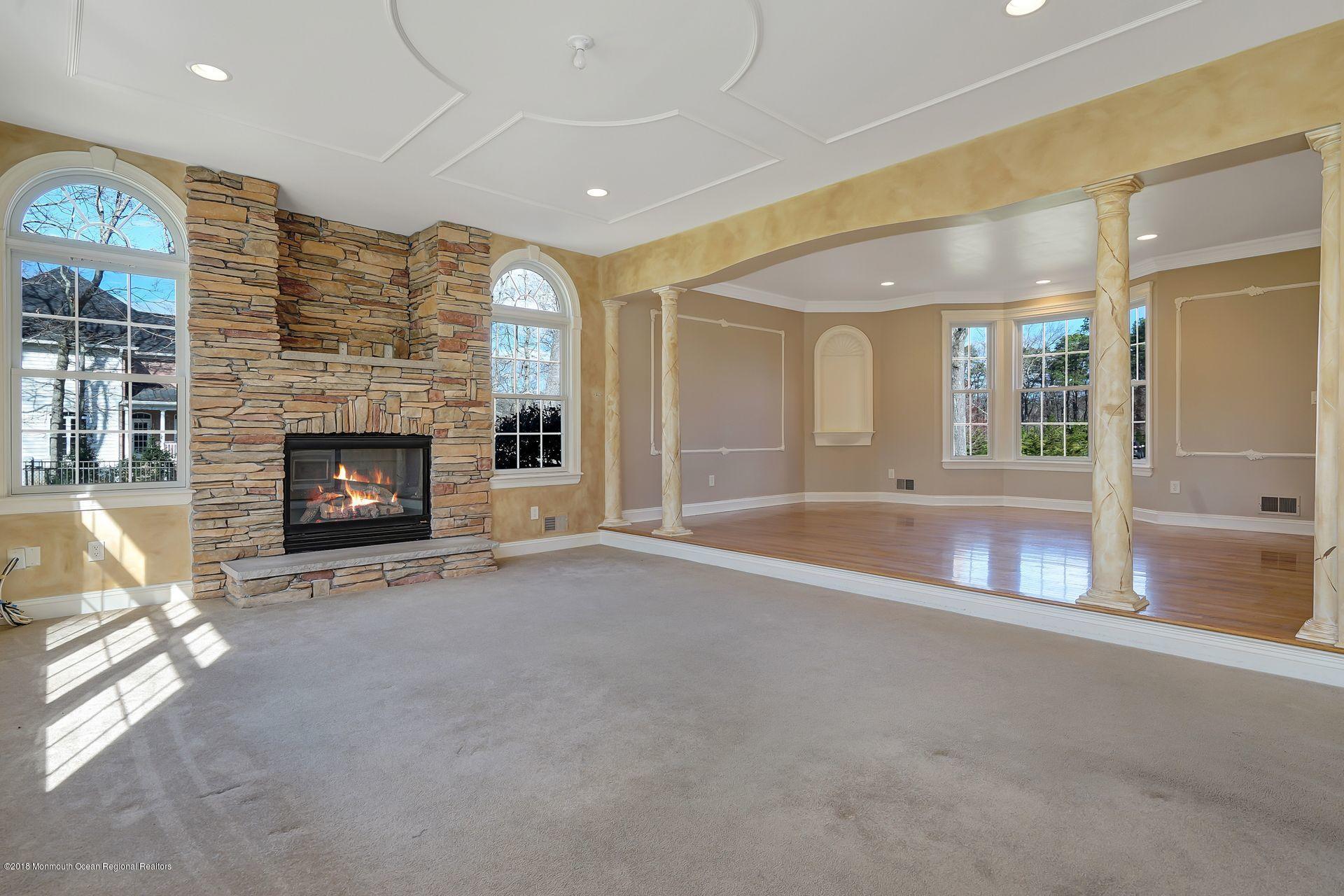 26 Conor Road Jackson, NJ 08527 - Photo 17 of 60 an empty room with fireplace and chandelier