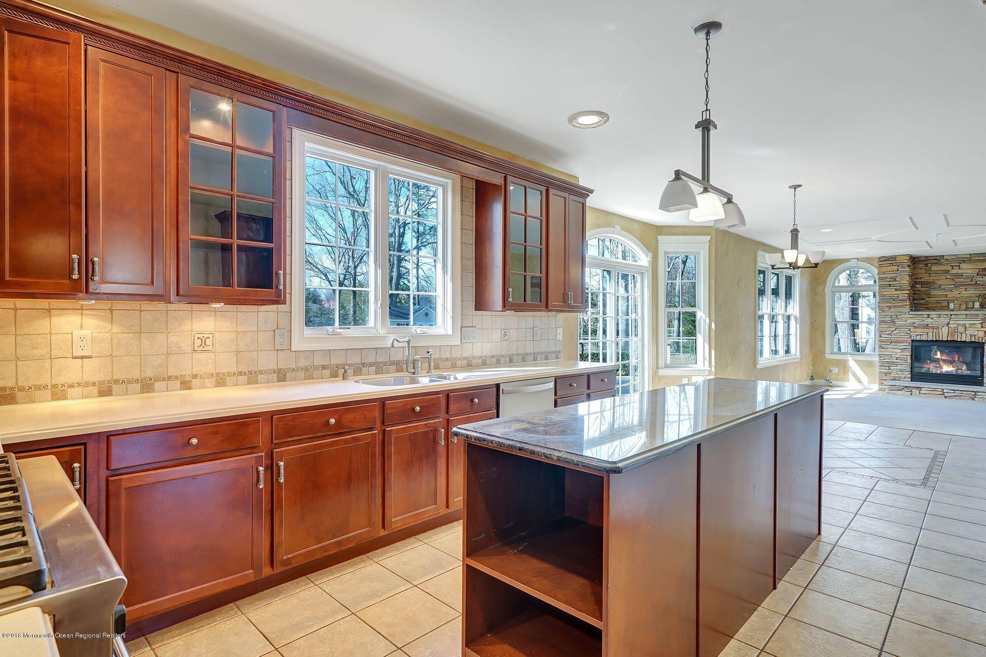 26 Conor Road Jackson, NJ 08527 - Photo 24 of 60 a kitchen with granite countertop sink stove and cabinets