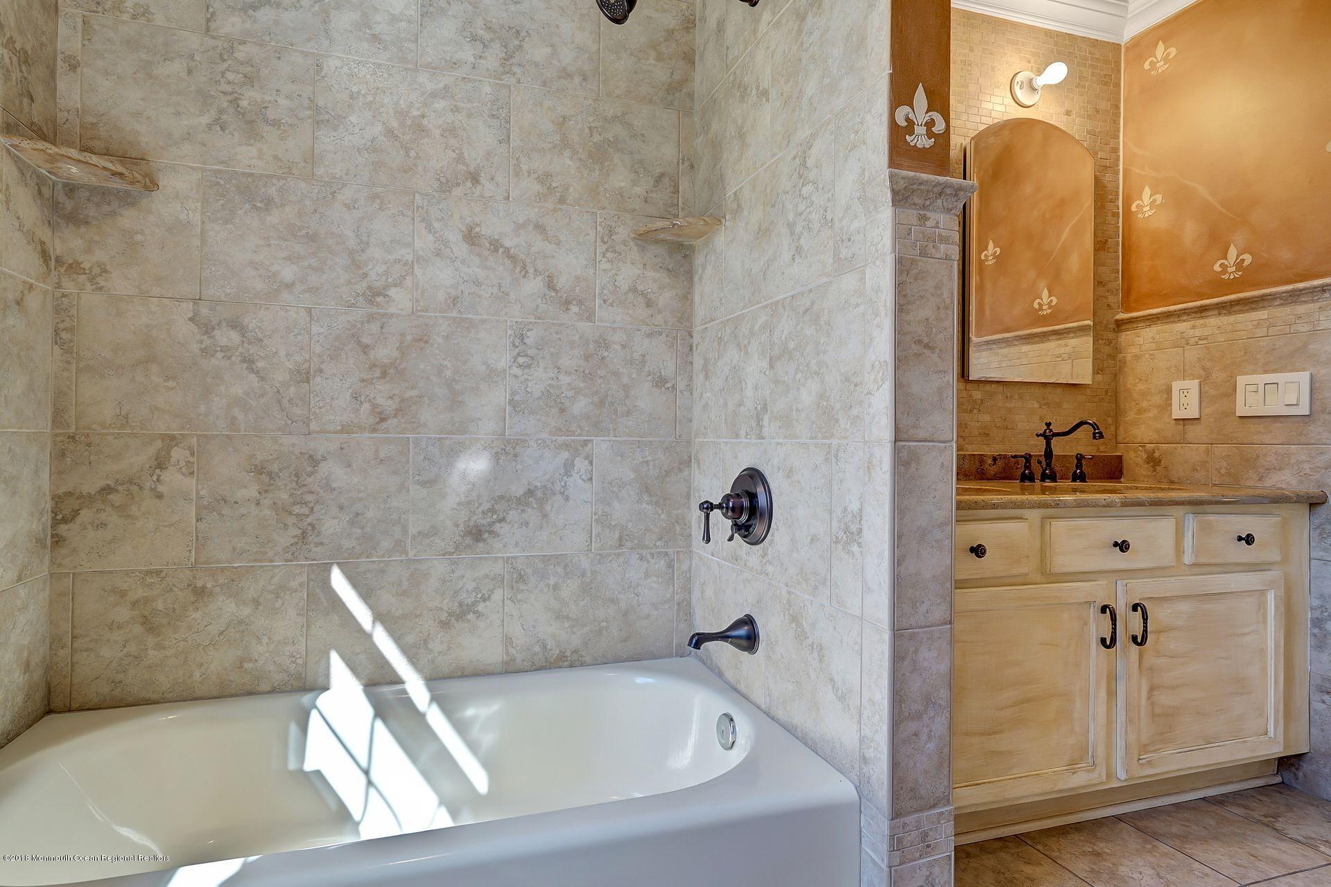 26 Conor Road Jackson, NJ 08527 - Photo 39 of 60 a bathroom with a bathtub