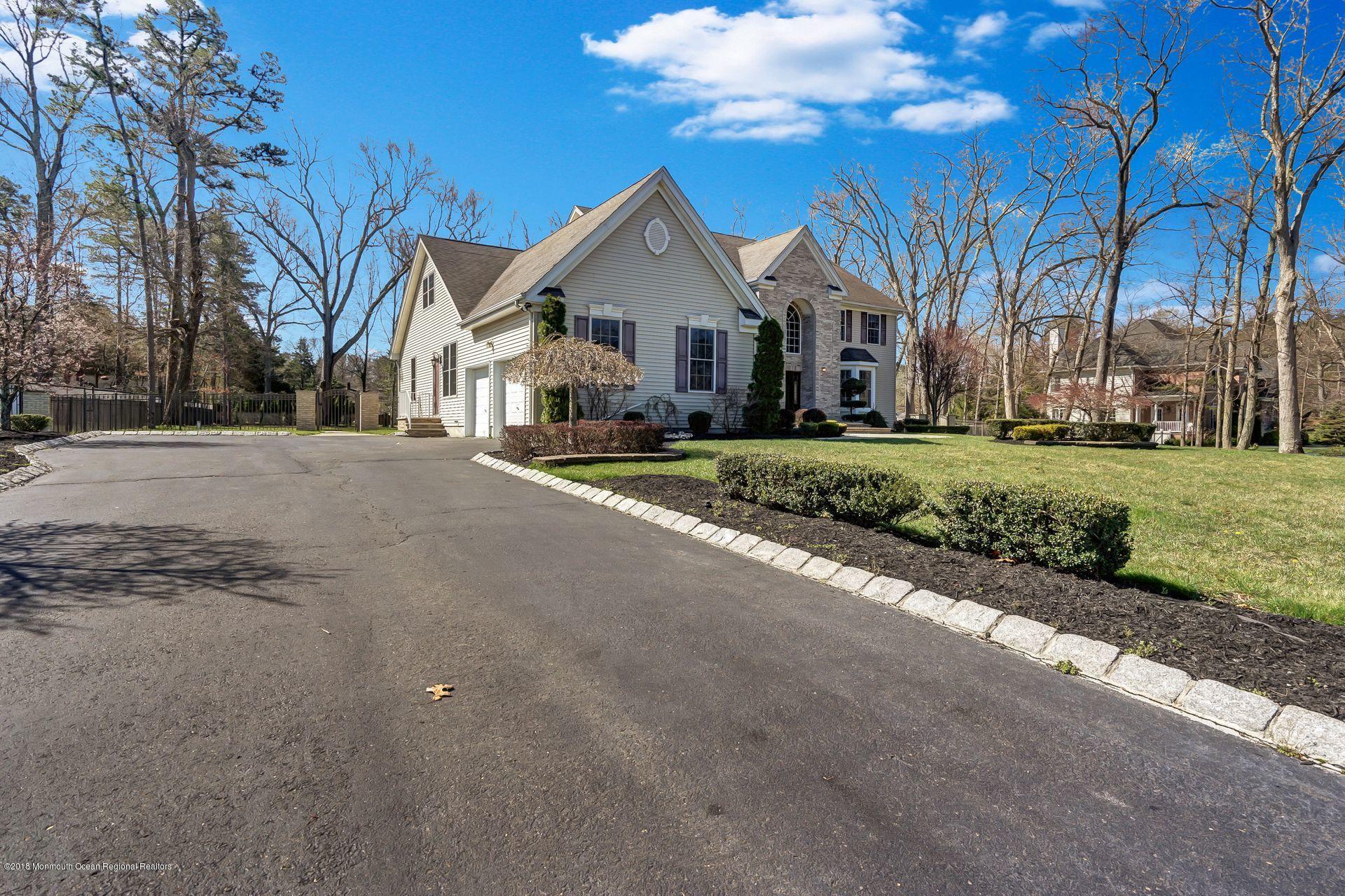 26 Conor Road Jackson, NJ 08527 - Photo 4 of 60 a front view of a house with a yard and garage