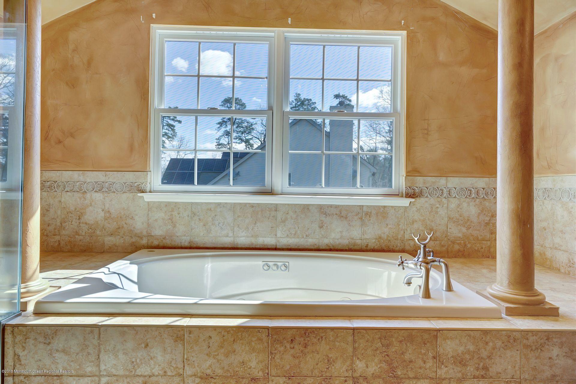 26 Conor Road Jackson, NJ 08527 - Photo 51 of 60 a view of a bathroom with tub and window